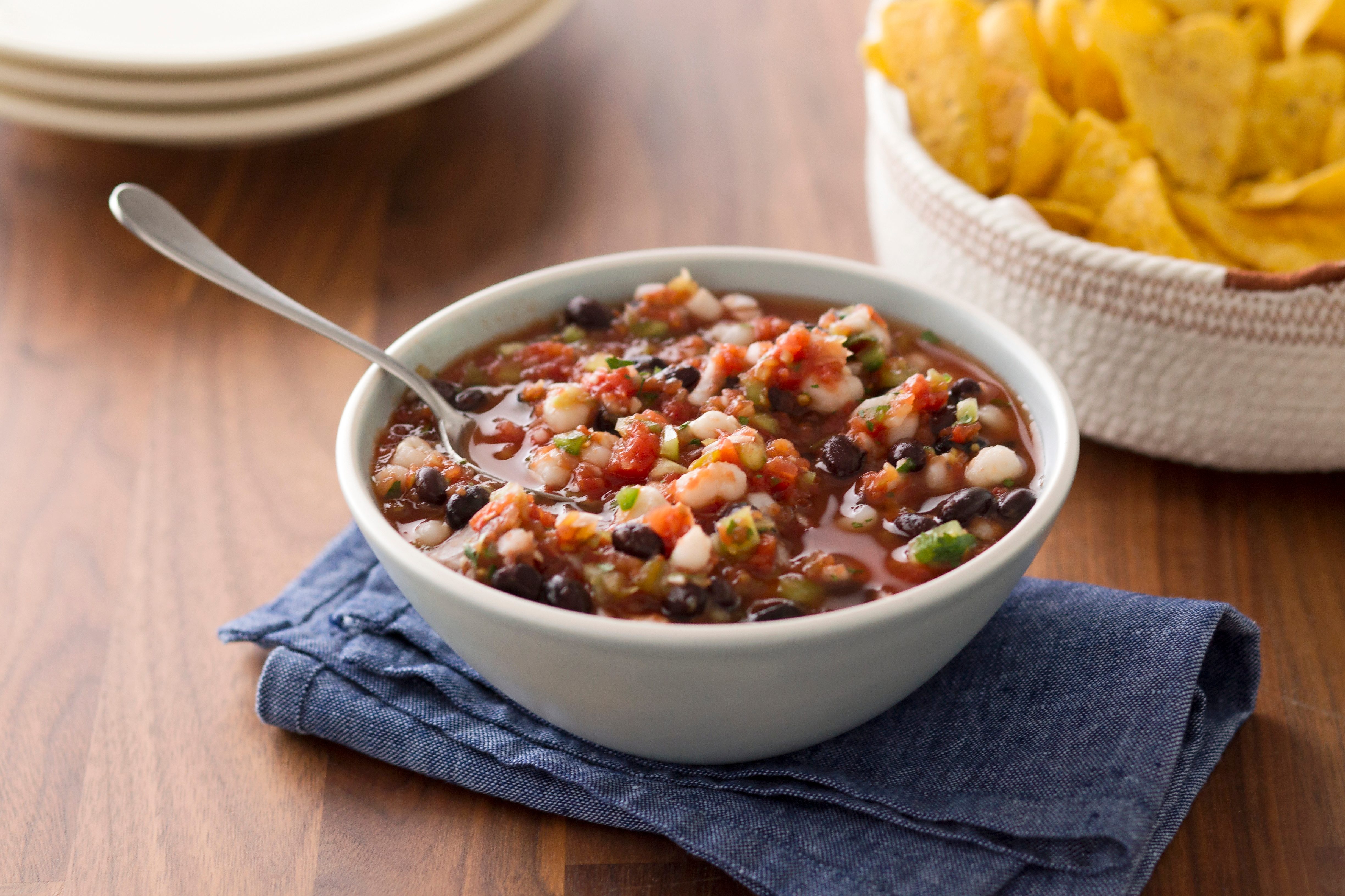 Homemade salsa in a bowl with another bowl nearby of tortilla chips
