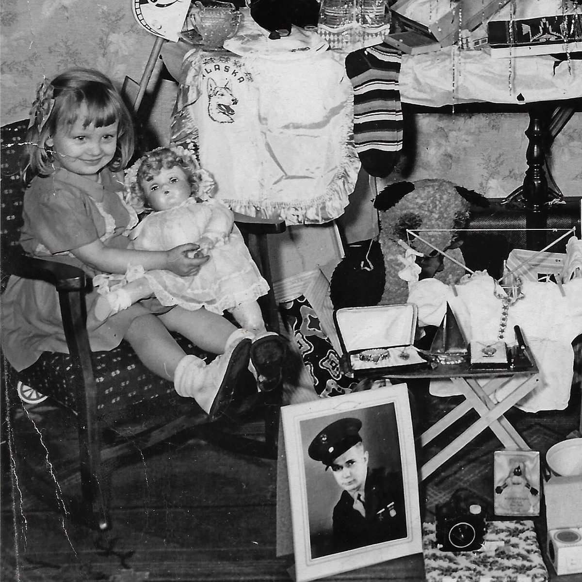 Photo of deployed family member beside the Christmas presents