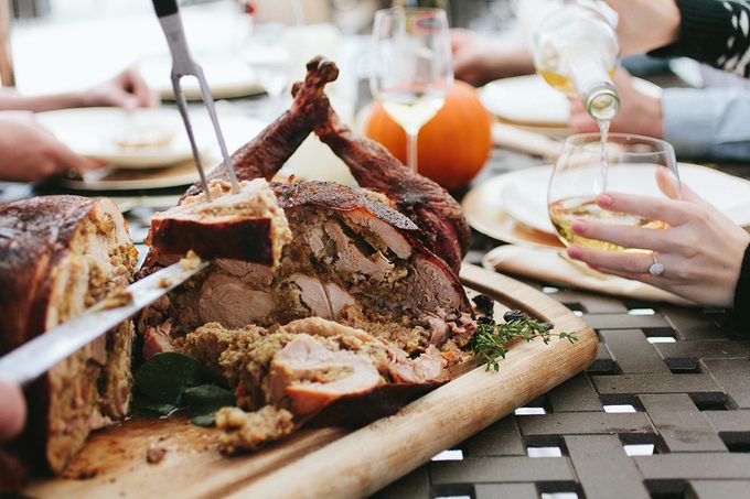 Carved turducken on a cutting board for people to grab slices of