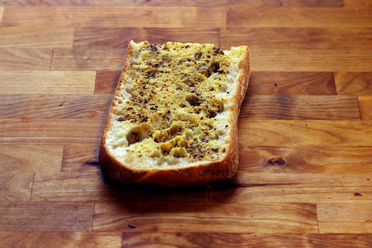 Piece of sliced bread on a wooden countertop