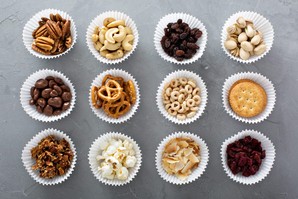 Variety of healthy snacks overhead shot laying on the table; cupcake liners