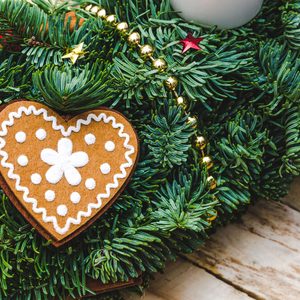 Advent Christmas wreath made natural pine with Heart shaped gingerbread cookie