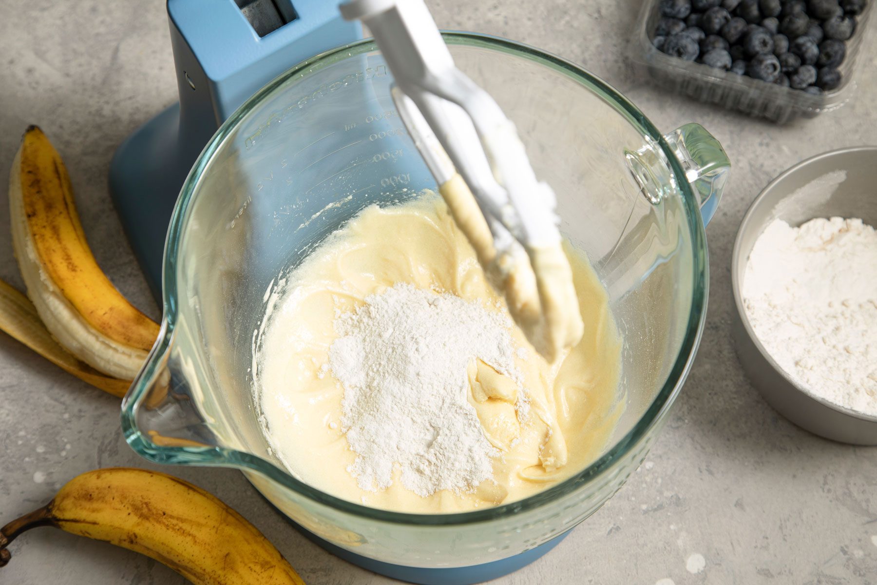 Flour in mixed in the cream mixture in a bowl