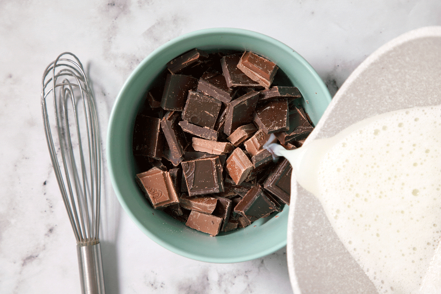 Pouring Hot Milk Mixture on Chocolate in a Small Bowl
