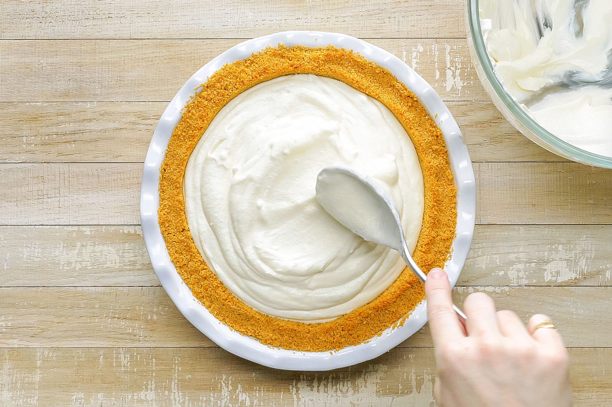 Setting Easy Cream Pie Filling on Crust in Plate on Wooden Surface
