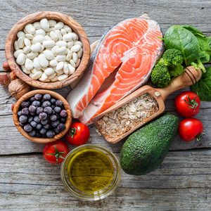 Selection of food that is good for the heart, rustic wood background