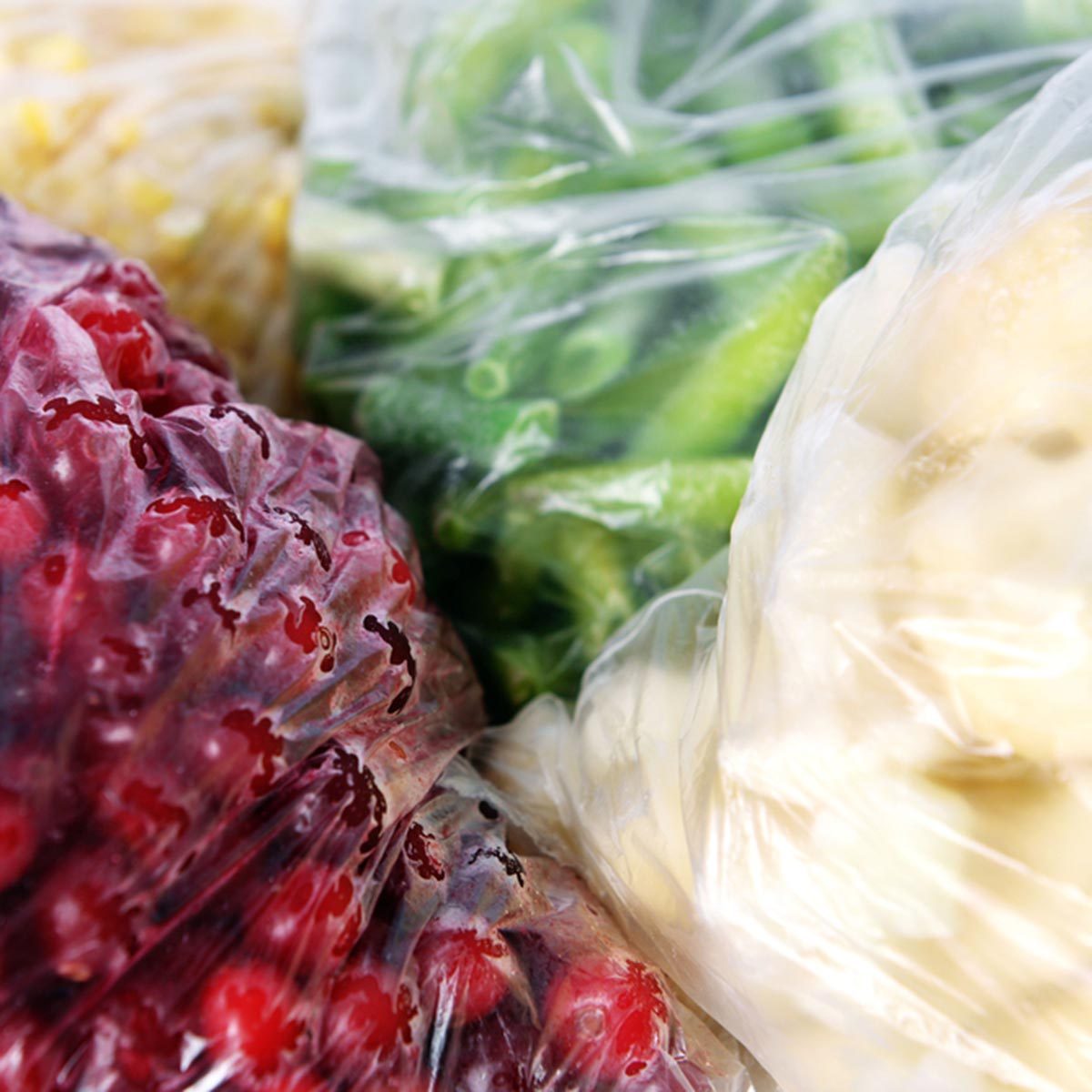 Frozen berries and vegetables in bags close up; Shutterstock ID 284295449