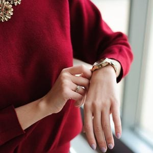 beautiful woman looks at the clock waiting for the plane at the airport
