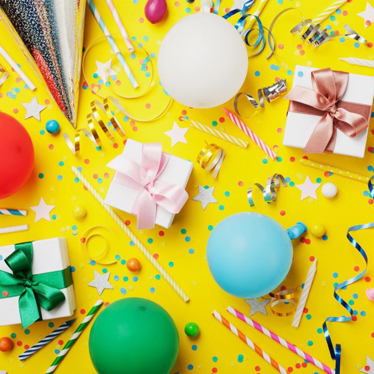 Birthday party background with balloon, gift, confetti, carnival cap, star, candy and streamer. Flat lay style. Colorful children greeting card.; Shutterstock ID 704524666; Job (TFH, TOH, RD, BNB, CWM, CM): TOH
