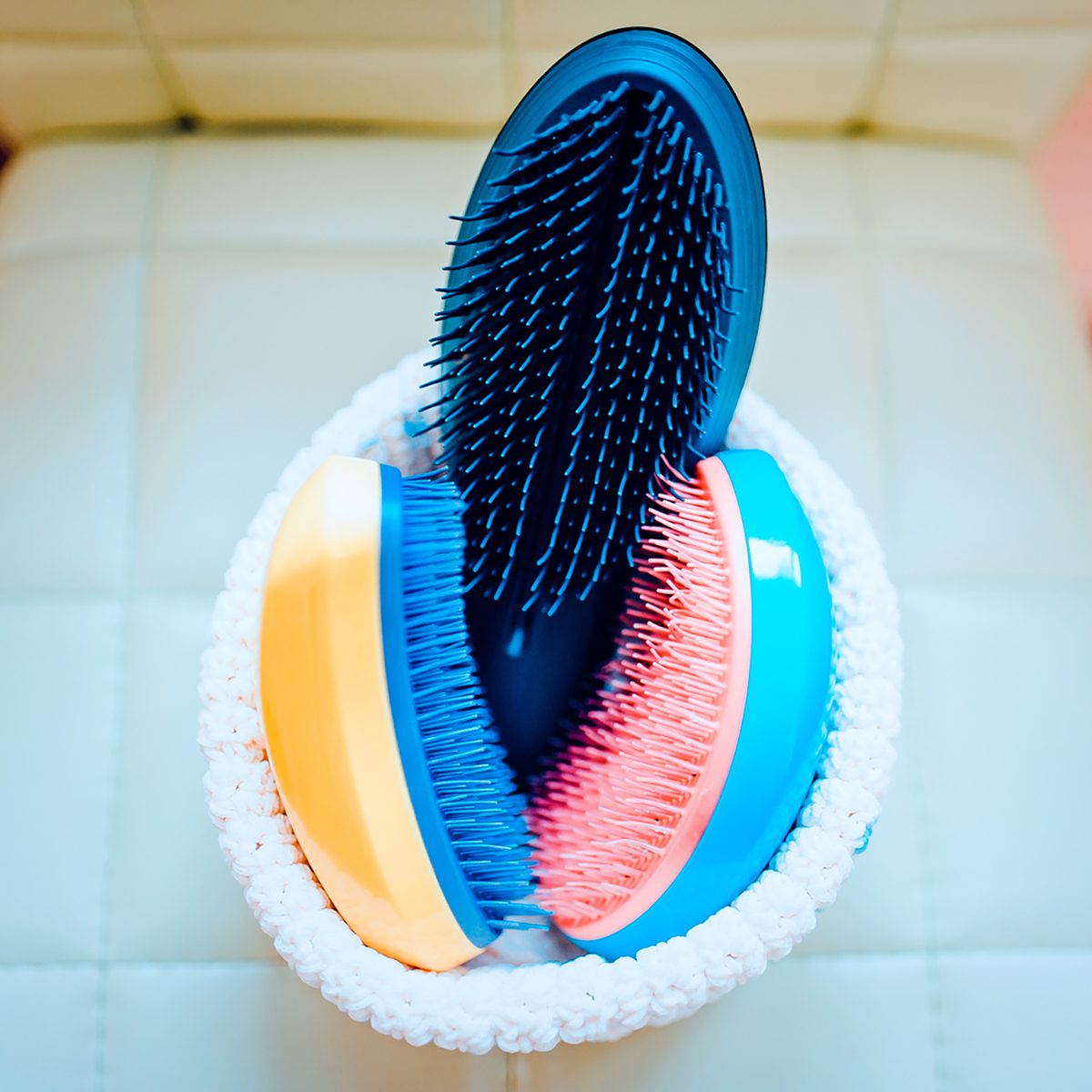 Basket with combs and round hair brushes. Toned image. Comb for combing raw hair in a basket in a hair salon. close up view; Shutterstock ID 1028801134; Job (TFH, TOH, RD, BNB, CWM, CM): TOH