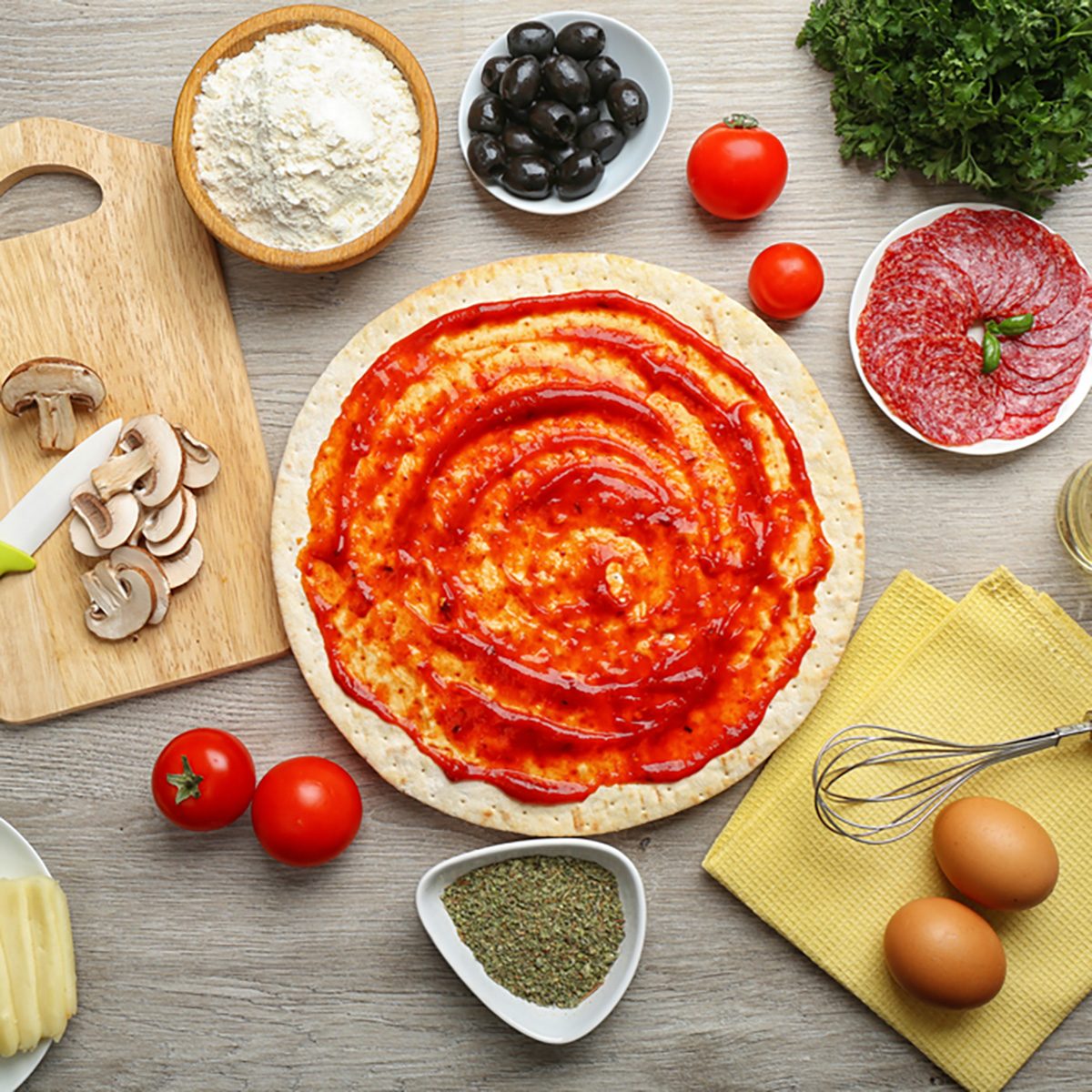 Cooking pizza on wooden table, top view