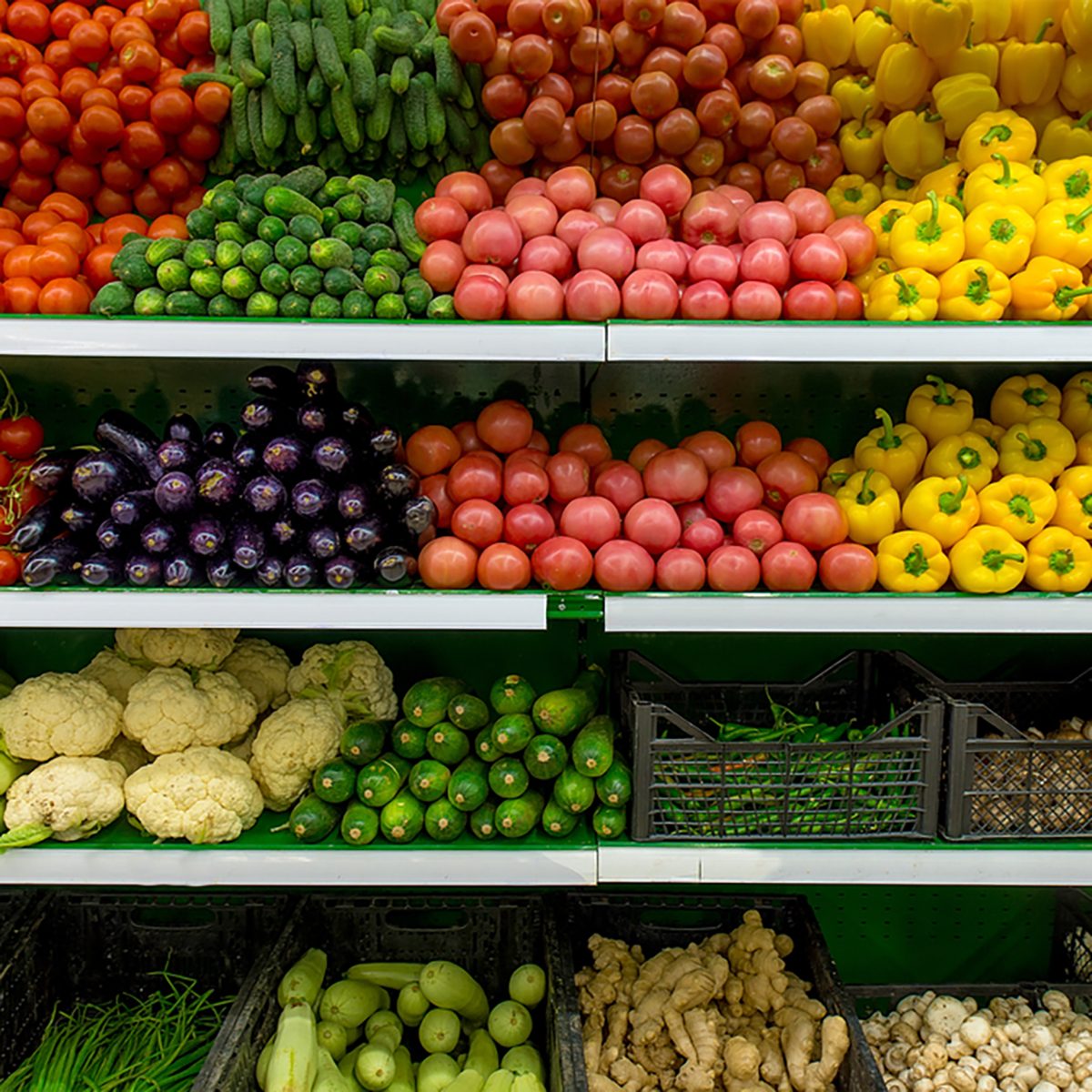 Fresh organic Vegetables and fruits on shelf in supermarket, farmers market. Healthy food concept. Vitamins and minerals. Tomatoes, capsicum, cucumbers, mushrooms, zucchini...