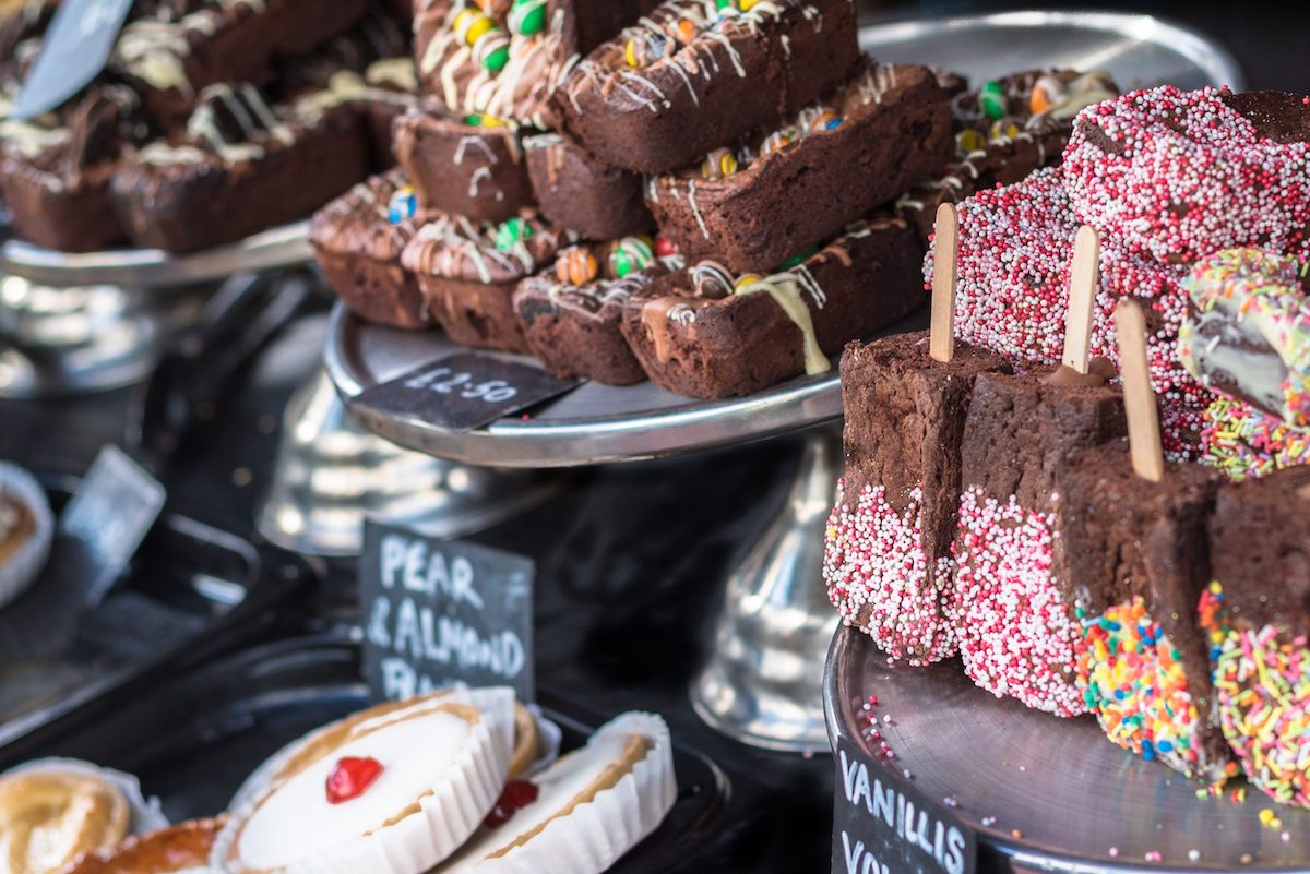 A selection of cakes and chocolate brownies for sale