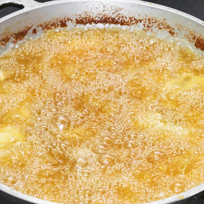 Frying food in a pan with hot and boiling oil.