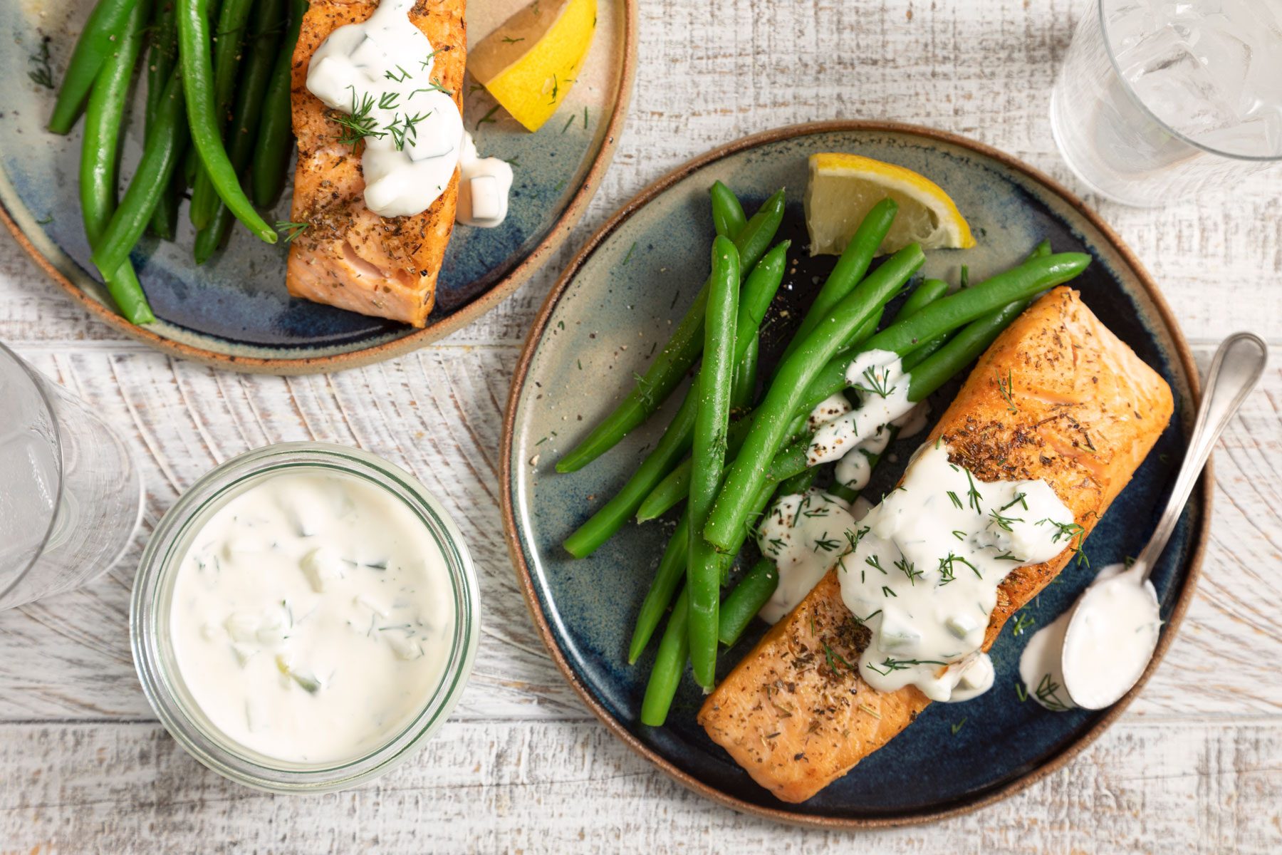 Pan Seared Salmon With Dill Sauce on a white table