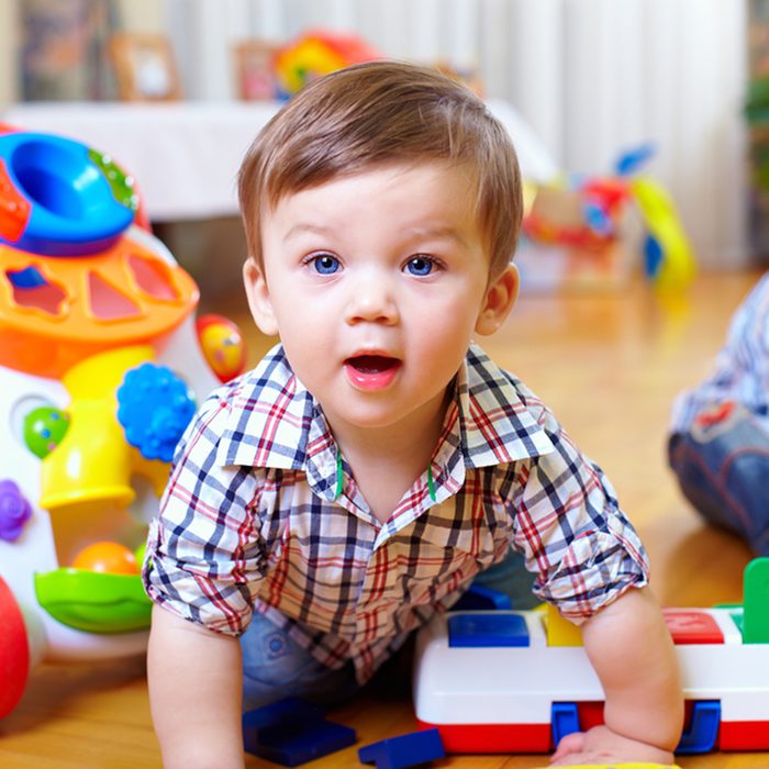 curious baby boy studying nursery room