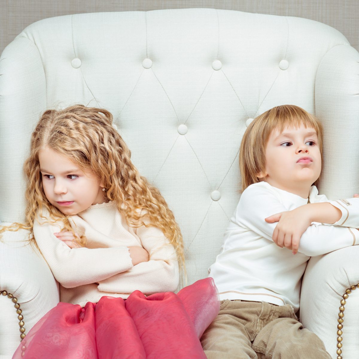 Cute little siblings (boy and girl) being at odds with each other