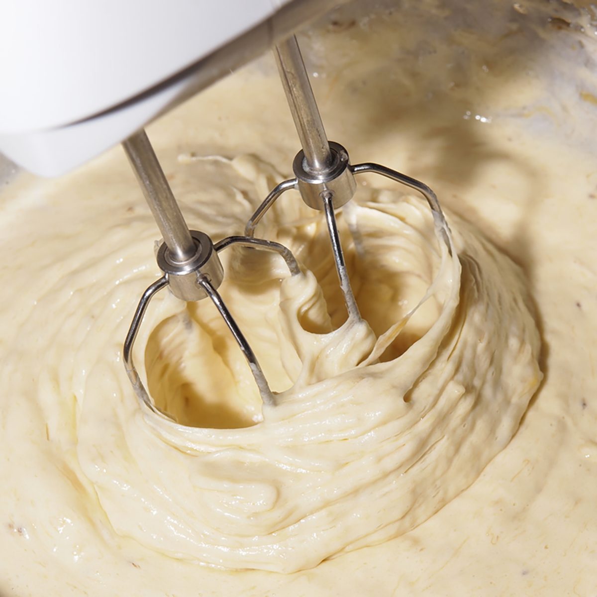 Mixing egg, banana, cake flour in bowl with motor mixer, baking banana cake