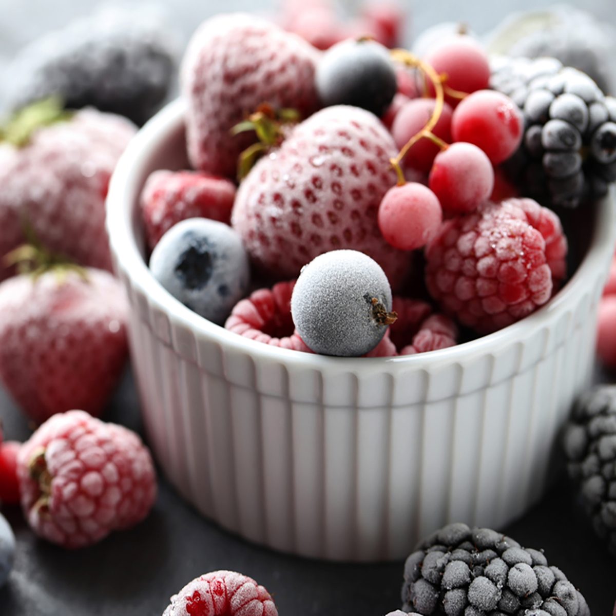 Frozen berries on a black wooden table