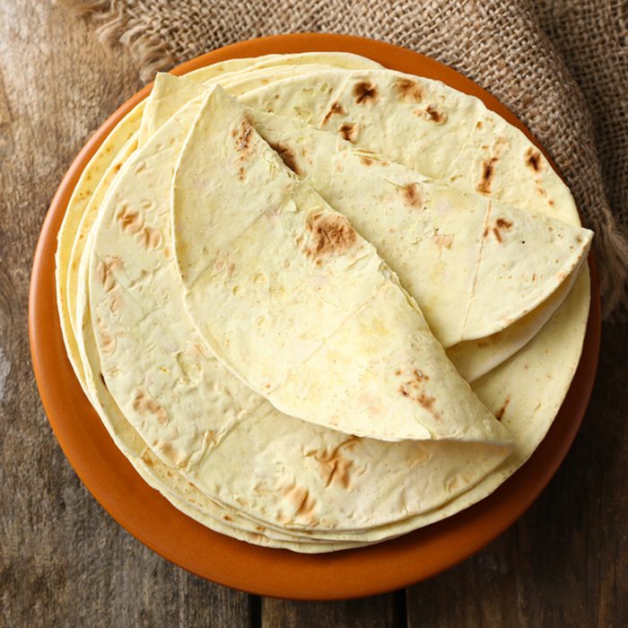 Stack of homemade whole wheat flour tortilla on plate