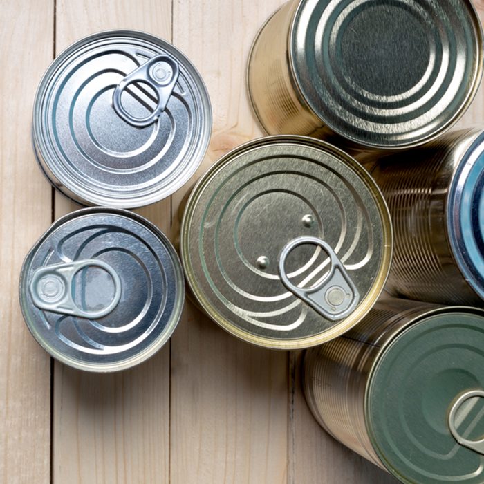 Tin cans for food on wooden background