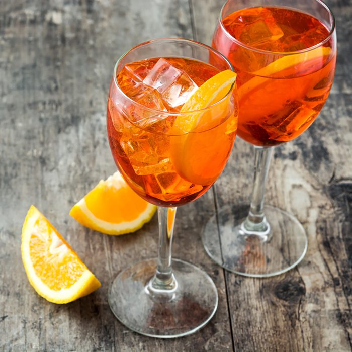 Aperol spritz cocktail in glass on wooden table