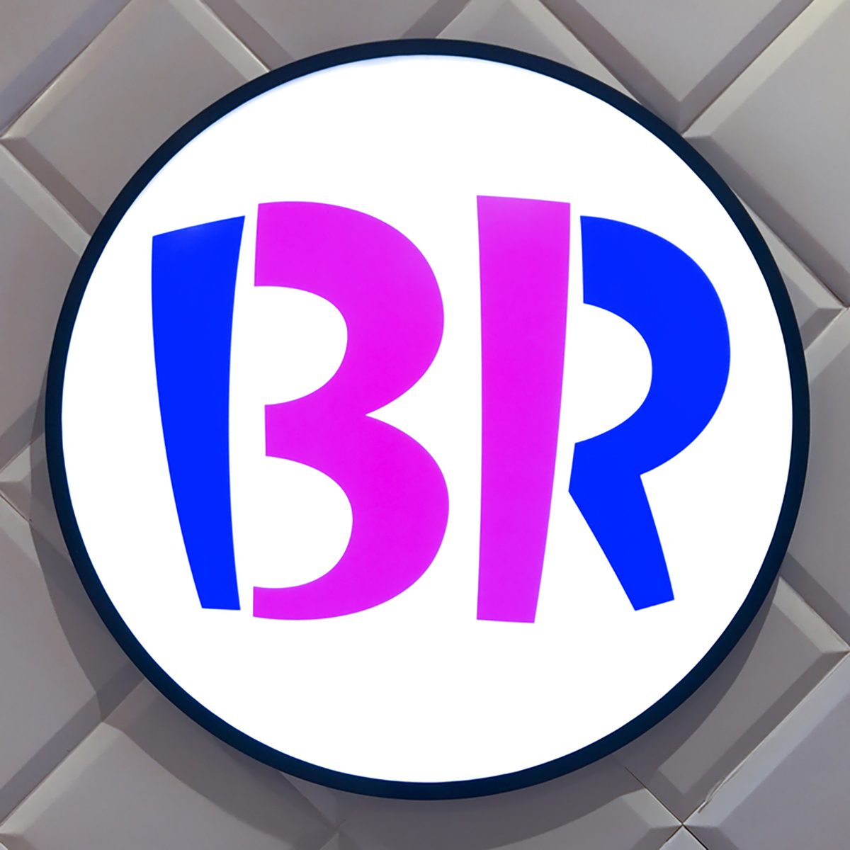 Large Baskin Robbins logo signage on white wall.