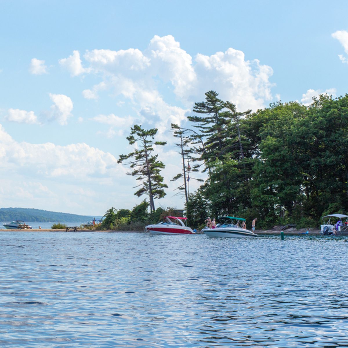 Boats anchored in Lake Michigan water at Power Island in west grand traverse by near Traverse City, Michigan