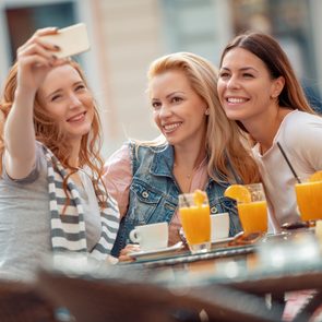 Friends having a great time in cafe.Friends smiling and sitting in a coffee shop, drinking coffee and enjoying together.; Shutterstock ID 1131394877; Job (TFH, TOH, RD, BNB, CWM, CM): TOH Girls Getaway