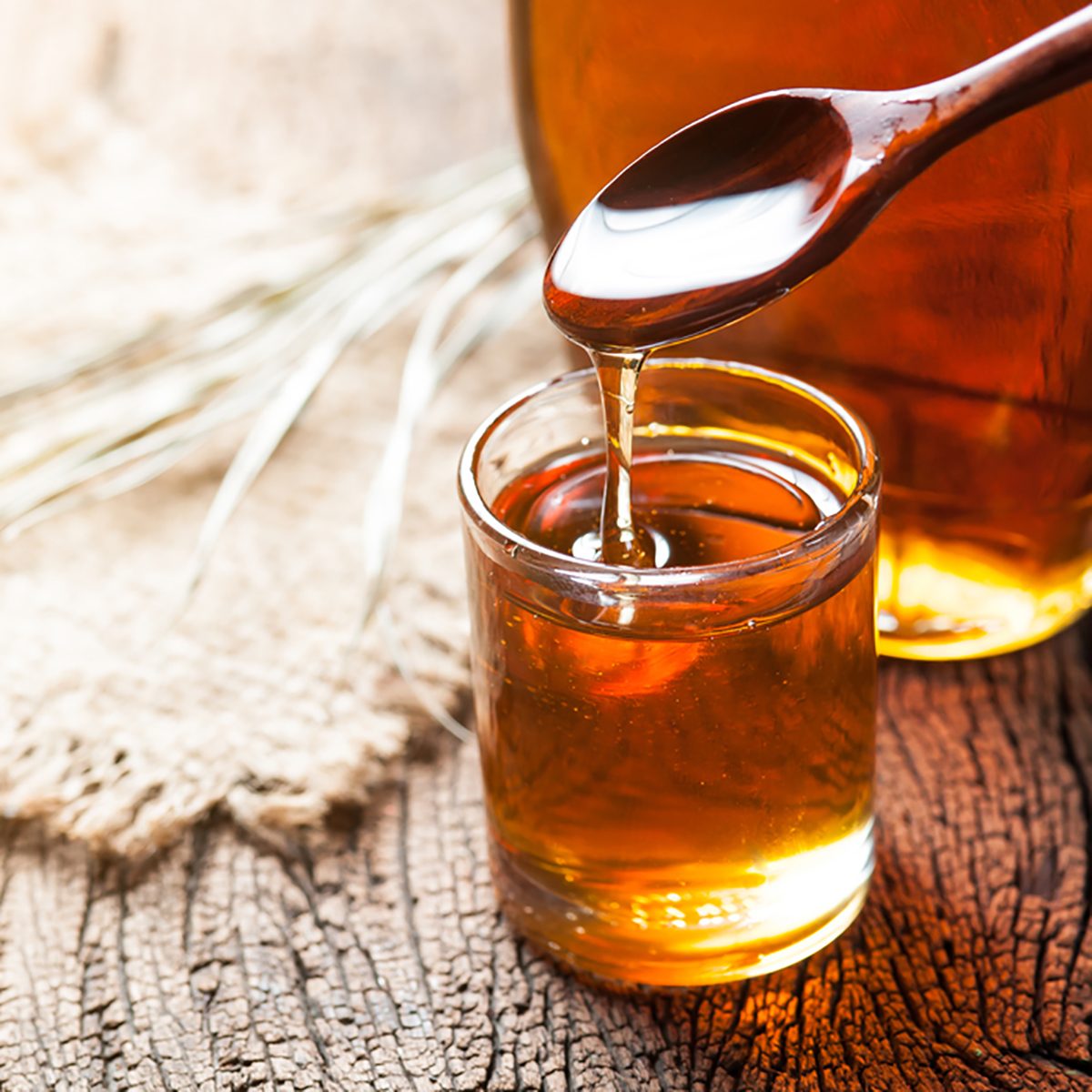 maple syrup in glass bottle on wooden table