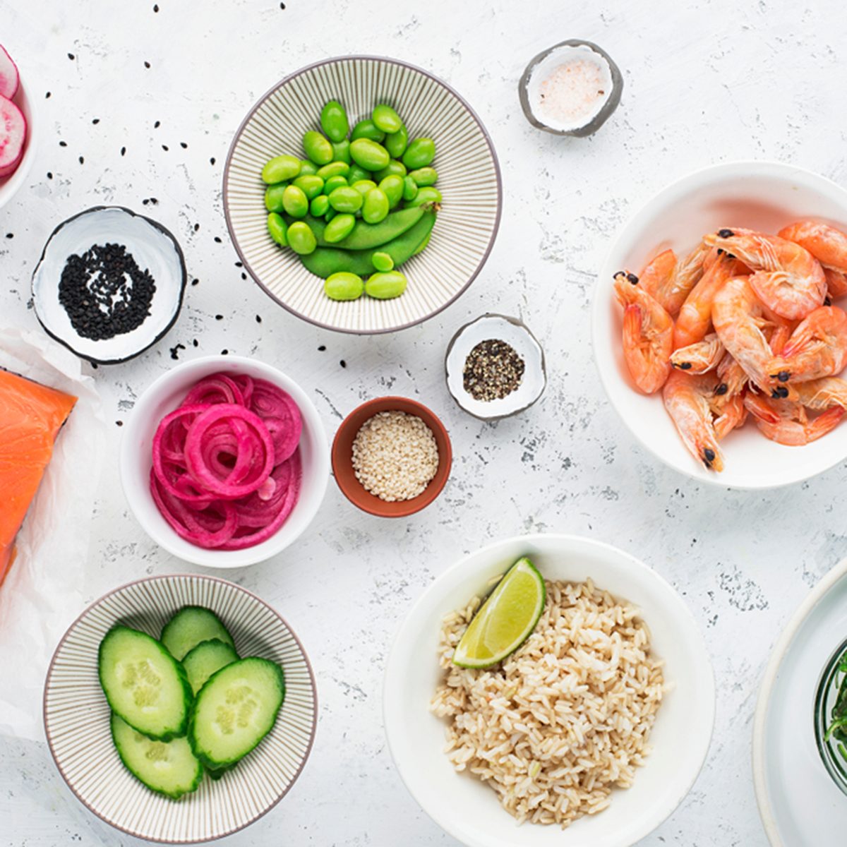 Fresh ingredients for prawn edamame salmon poke bowl.