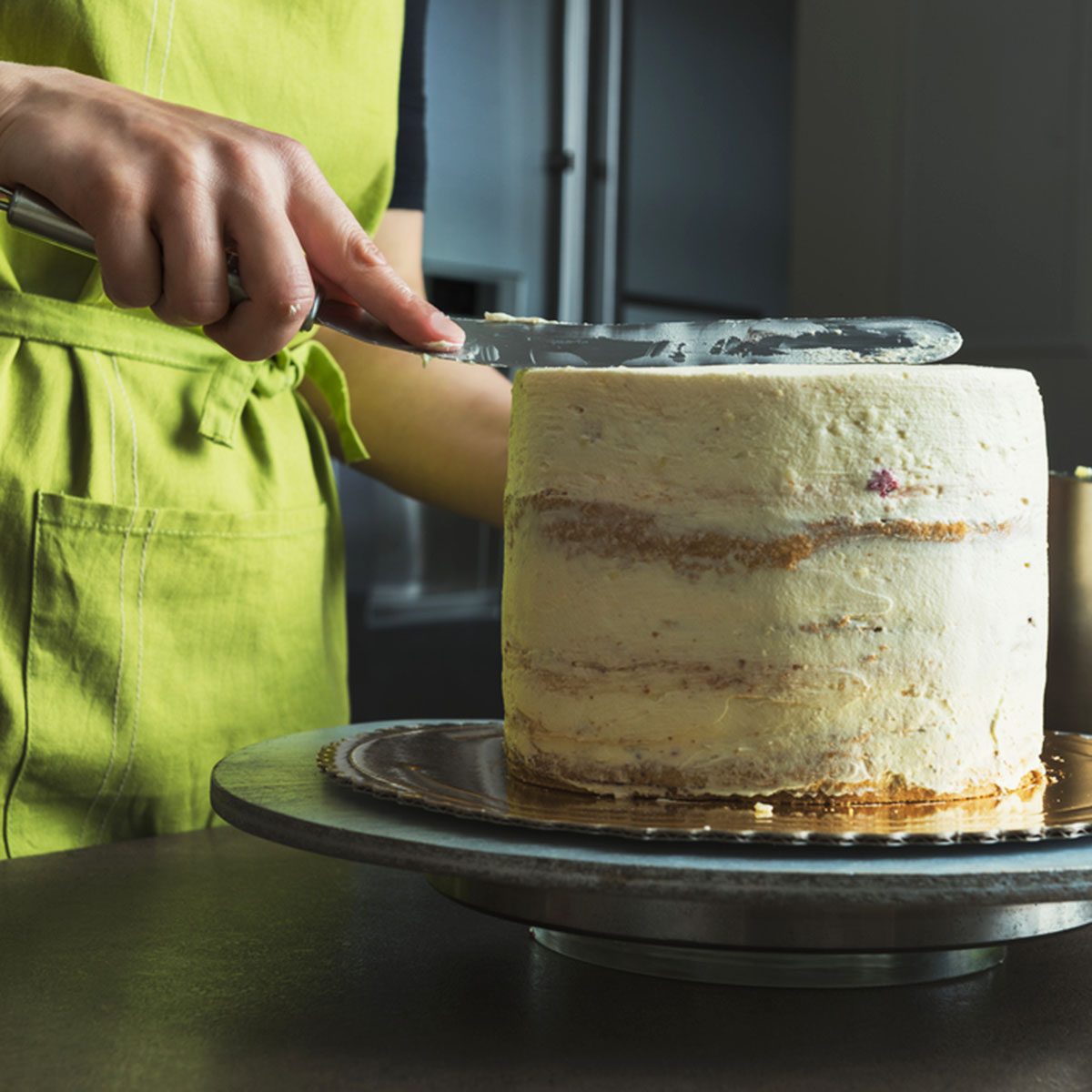 woman showing how to frost a cake