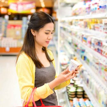Woman reading product in grocery store