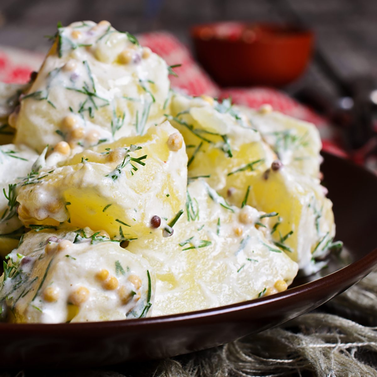 Potato salad with mustard seeds and white filling in rustic style