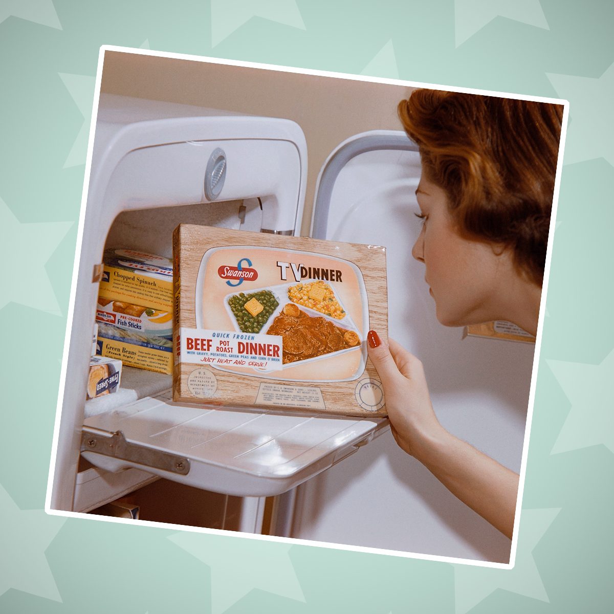 A woman examines a TV dinner box she has taken from the freezer
