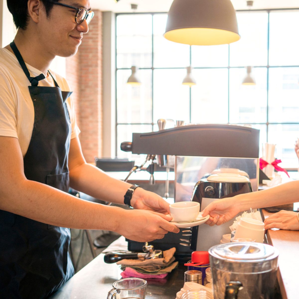 beautiful woman order a coffee to barista in a coffee shop