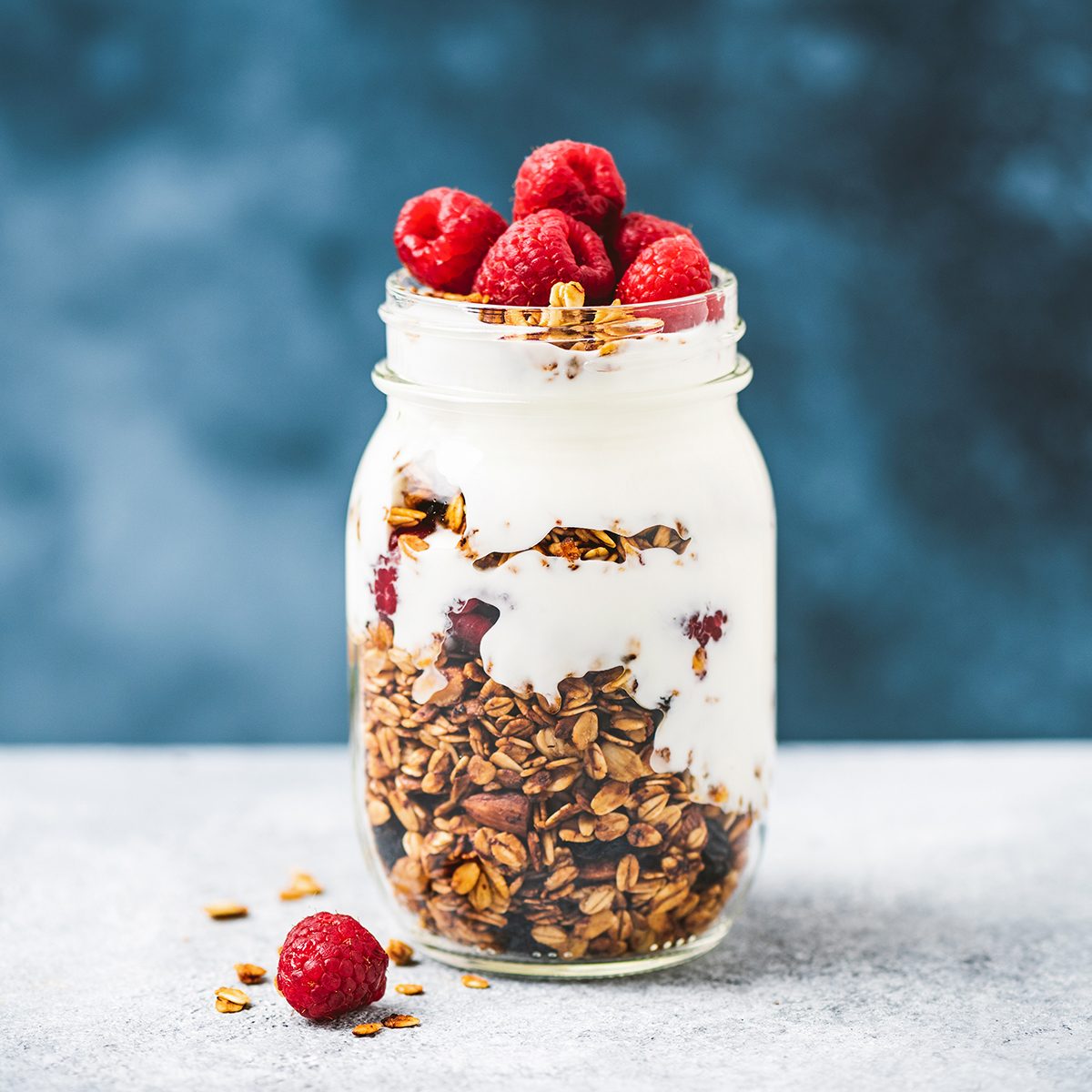 Granola with greek yogurt and raspberries in jar, healthy food, healthy eating concept