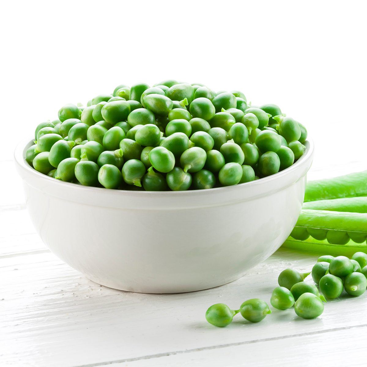 Organic Green Peas in a Bowl on White Table