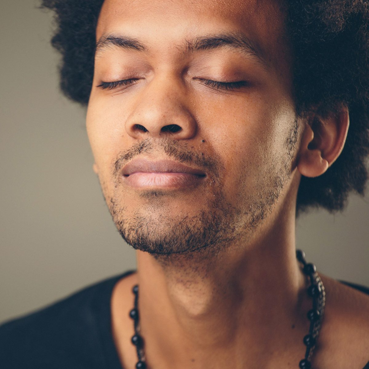 Portrait handsome young man, eyes closed.