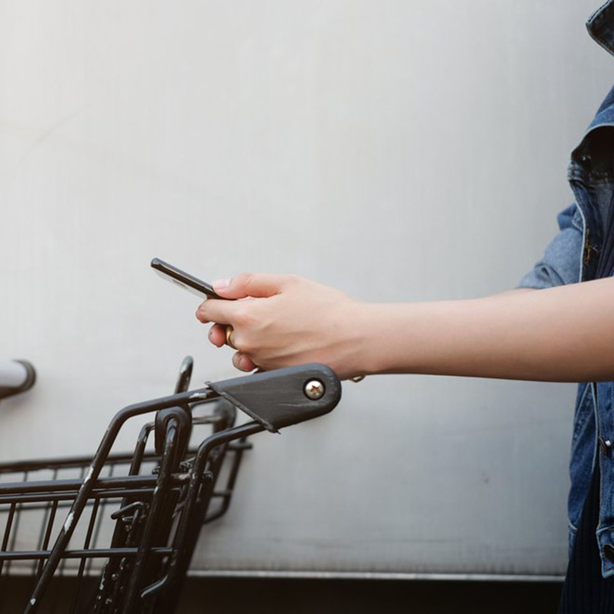 Person on their phone at cart