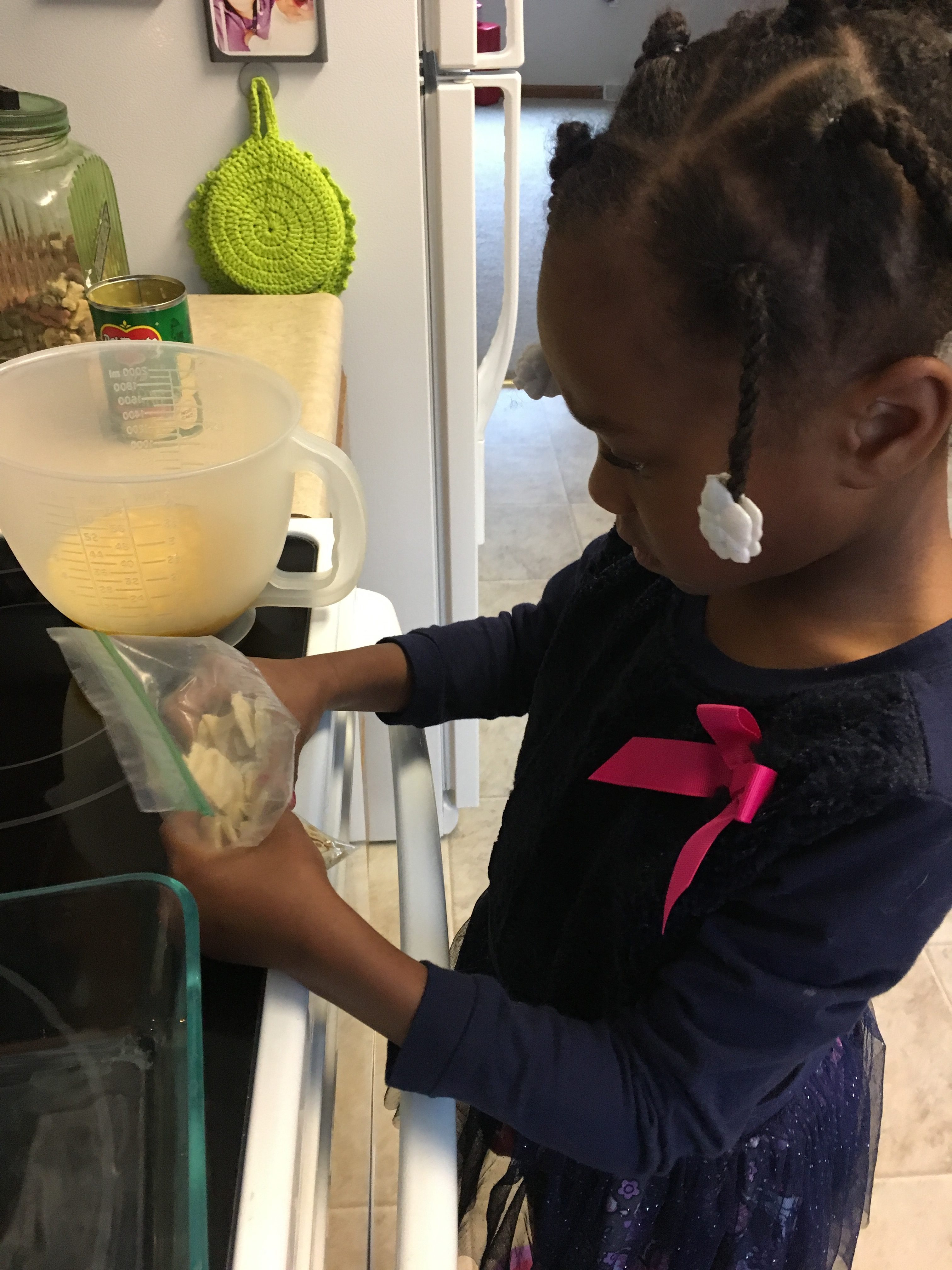 Child helping in kitchen