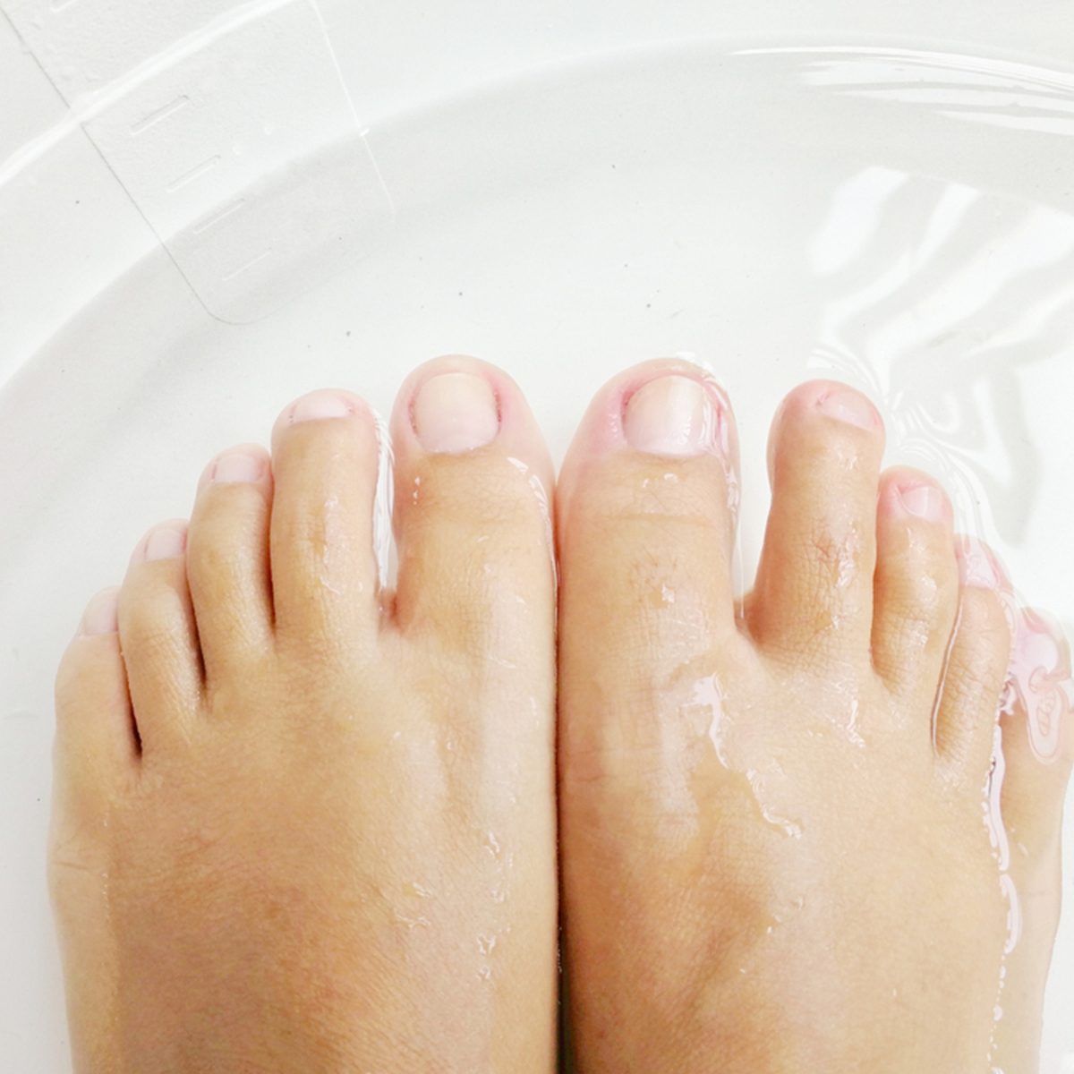 Women soak foots in the tub to relax and ready for cutting nails.