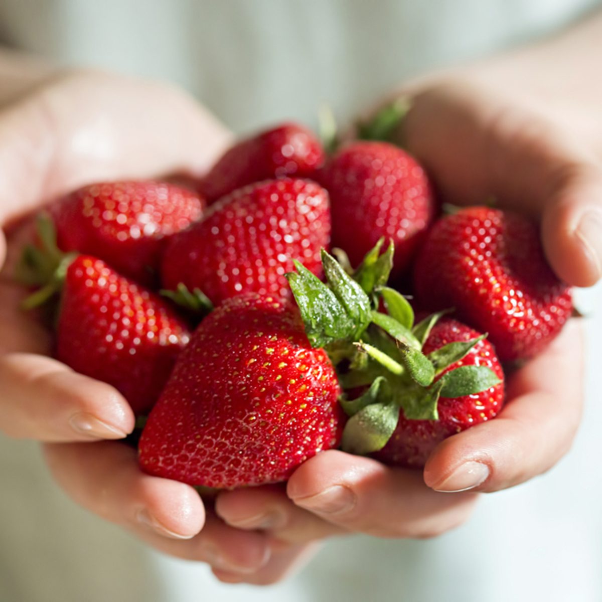Man hands holding fresh strawberries