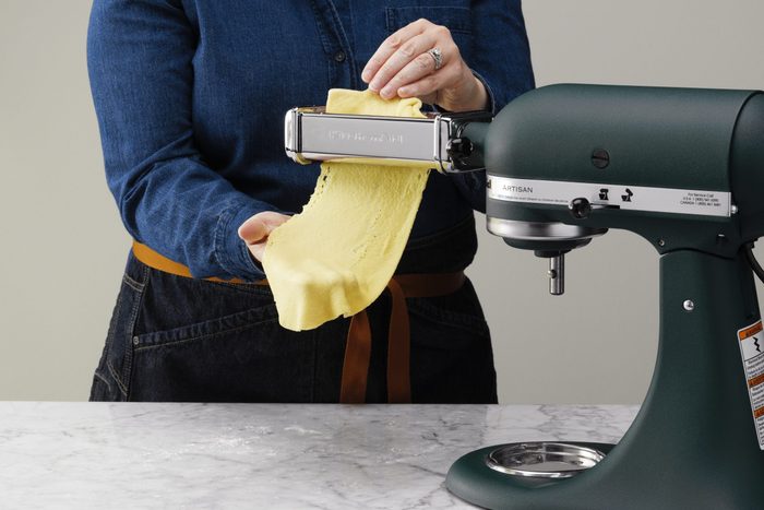 feed the pasta dough to the machine