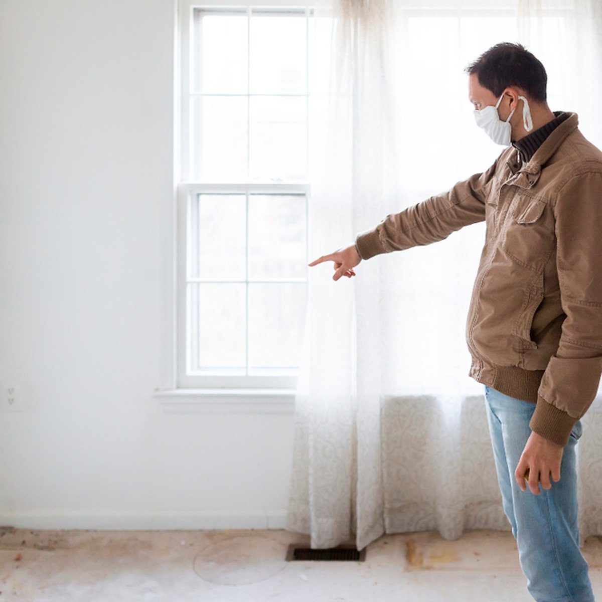 Man pointing at window