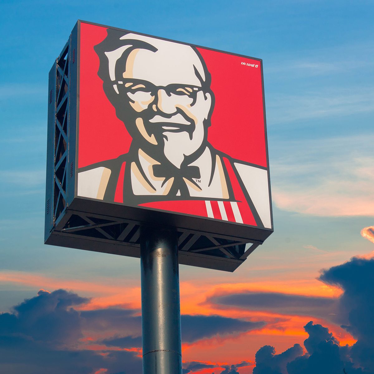 KFC logo against a sunset