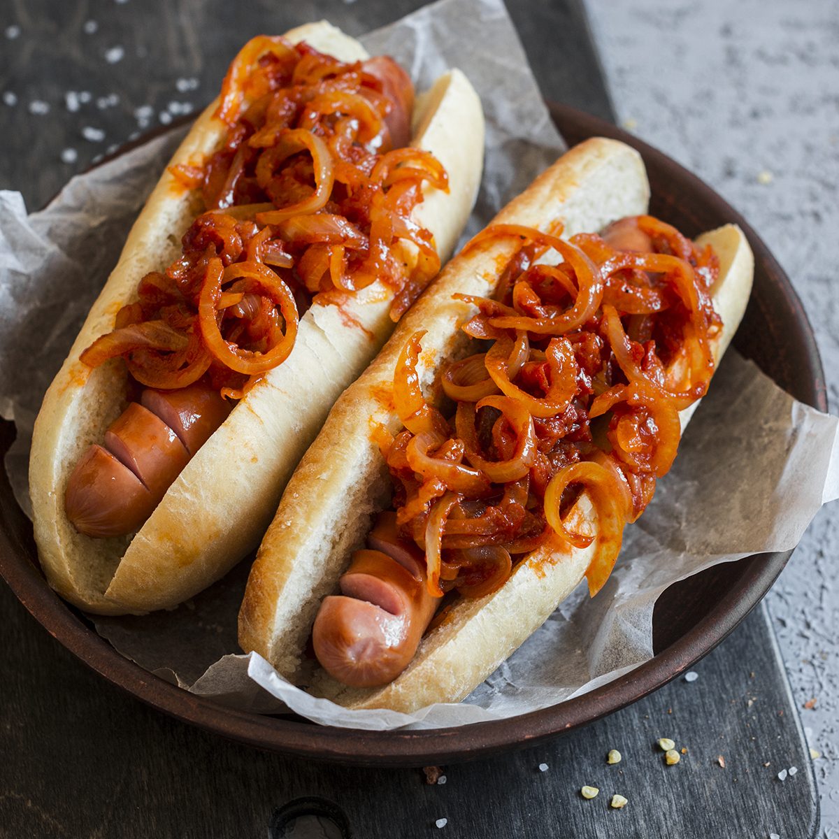 Hot dog with New York street style tomato onion sauce on a wooden background