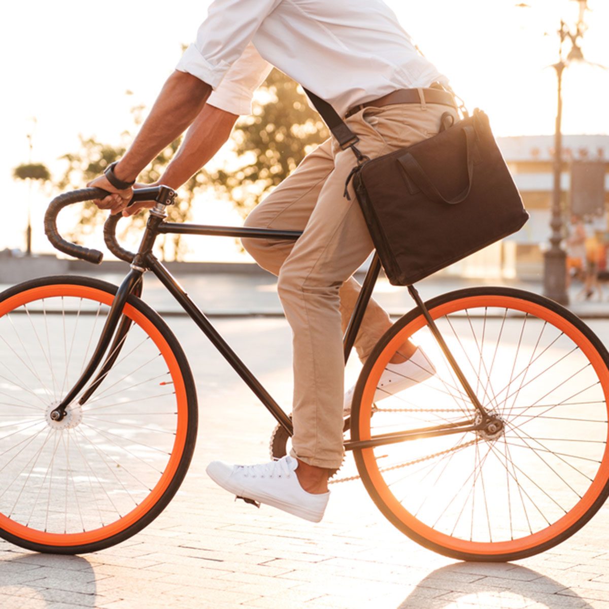 Cropped picture of handsome young african man early morning with bicycle