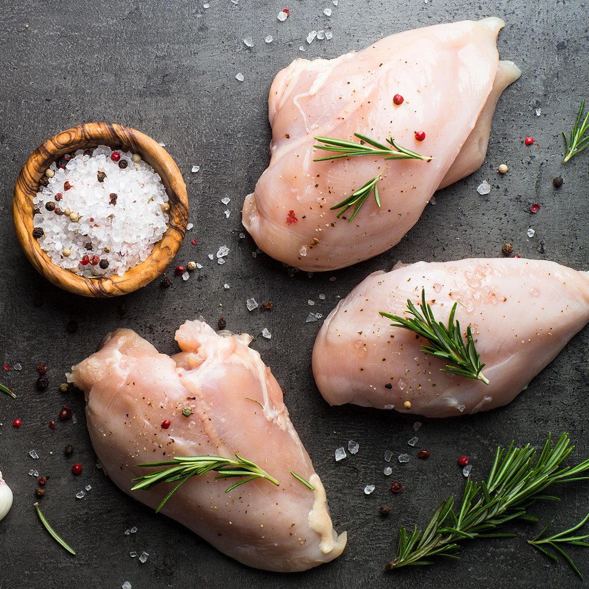 Raw chicken fillet with spices.