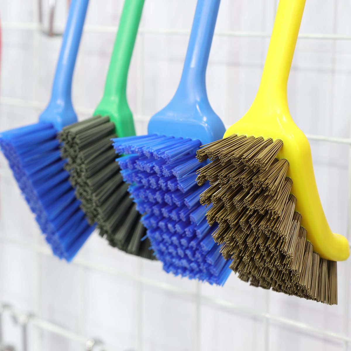plastic cleaning brushes in supermarket hanger ; close up